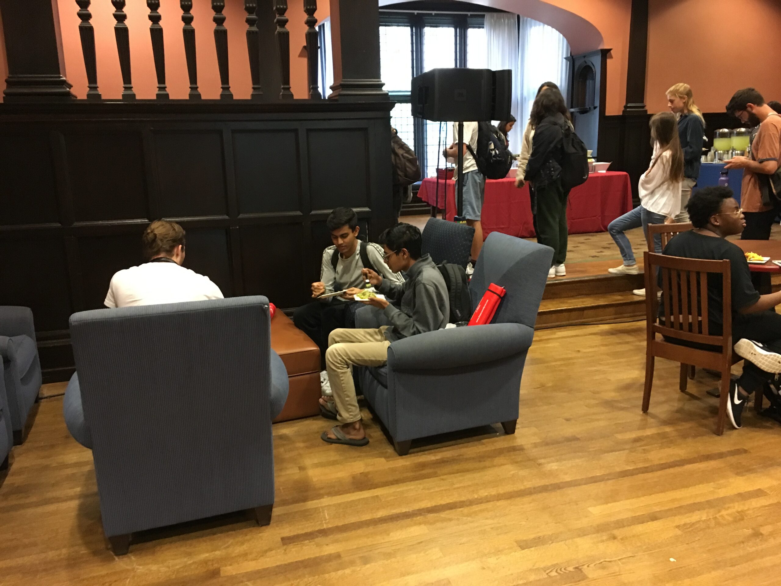 Students relaxing at cafe tables and lounge furniture enjoying the Houston Hall Market's new tasting menu